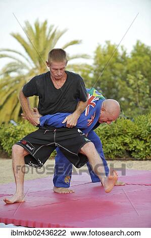 Two men doing martial arts training in a park View Large Photo Image Stock Image - Two men doing martial arts training in a park. Fotosearch