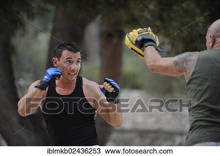 Two men doing martial arts training in a park View Large Photo Image Stock Image - Two men doing martial arts training in a park. Fotosearch