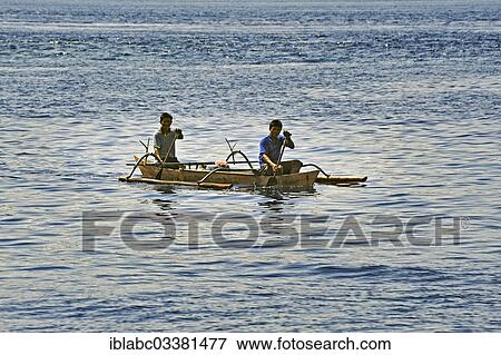 Stock Photo - "Two men in an outrigger boat, Arborek, Raja Ampat, West Papua, Indonesia, Asia". Fotosearch
