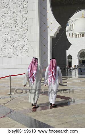 "Two men in Arab dress walking in front of the Sheikh Zayed Mosque, Abu Dhabi, United Arab Emirates, Asia" View Large Photo Image Stock Image - "Two men in Arab dress walking in front of the Sheikh Zayed Mosque, Abu Dhabi, United Arab Emirates, Asia". Fotosearch