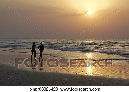 "Two men jogging on the beach at sunset, silhouette, Al-Batinah province, Oman, Arabian Peninsula, Asia" View Large Photo Image Stock Photo - "Two men jogging on the beach at sunset, silhouette, Al-Batinah province, Oman, Arabian Peninsula, Asia". Fotosearch