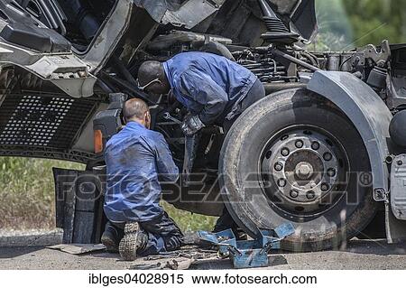 "Two men repairing a truck, Mozambique, Africa" View Large Photo Image Stock Photography - "Two men repairing a truck, Mozambique, Africa". Fotosearch