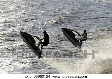 Picture - "Two men riding water scooters, Ystad, Scania, Sweden, Europe". Fotosearch