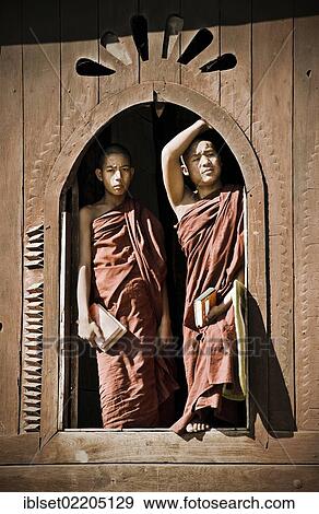 "Two monks standing at a window of the Shwe Yan Bye monastery in Burma, Myanmar, Southeast Asia, Asia" View Large Photo Image Stock Photo - "Two monks standing at a window of the Shwe Yan Bye monastery in Burma, Myanmar, Southeast Asia, Asia". Fotosearch
