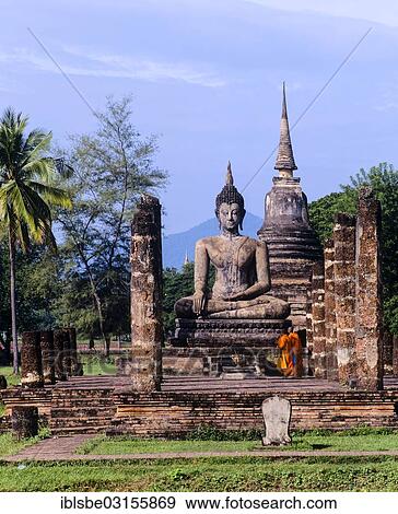 "Two monks standing in front of the seated Buddha at Wat Mahathat, temple ruins, chedi, Sukhothai Historical Park, Sukhothai, Sukhothai Province, Northern Thailand, Thailand, Asia" View Large Photo Image Stock Photo - "Two monks standing in front of the seated Buddha at Wat Mahathat, temple ruins, chedi, Sukhothai Historical Park, Sukhothai, Sukhothai Province, Northern Thailand, Thailand, Asia". Fotosearch