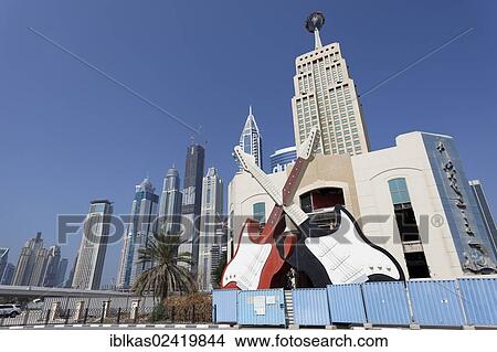 Two monumental, crossed guitars, sign for a nightclub located on Sheikh Zayed Road, Dubai, United Arab Emirates, Middle East, Asia View Large Photo Image Picture - Two monumental, crossed guitars, sign for a nightclub located on Sheikh Zayed Road, Dubai, United Arab Emirates, Middle East, Asia. Fotosearch