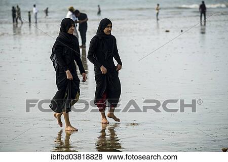 "Two Muslim girls walking along Juhu Beach, Mumbai, Maharashtra, India, Asia" View Large Photo Image Stock Photo - "Two Muslim girls walking along Juhu Beach, Mumbai, Maharashtra, India, Asia". Fotosearch