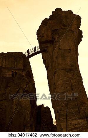 "Two people on a bridge, Externsteine, sandstone rock formations, Horn-Bad Meinberg, Teutoburg Forest, North Rhine-Westphalia, Germany, Europe" View Large Photo Image Stock Image - "Two people on a bridge, Externsteine, sandstone rock formations, Horn-Bad Meinberg, Teutoburg Forest, North Rhine-Westphalia, Germany, Europe". Fotosearch