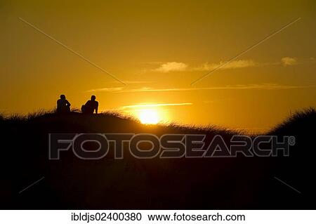 "Two people on dune at sunset, Amrum, North Frisian Islands, Schleswig-Holstein, Germany, Europe" View Large Photo Image Stock Image - "Two people on dune at sunset, Amrum, North Frisian Islands, Schleswig-Holstein, Germany, Europe". Fotosearch