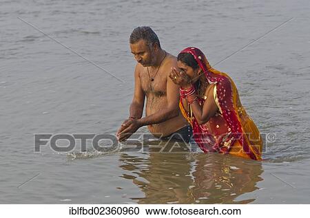 "Two pilgrims praying in the water at Sangam, the confluence of the holy rivers Ganges, Yamuna and Saraswati, Allahabad, India, Asia" View Large Photo Image Stock Image - "Two pilgrims praying in the water at Sangam, the confluence of the holy rivers Ganges, Yamuna and Saraswati, Allahabad, India, Asia". Fotosearch