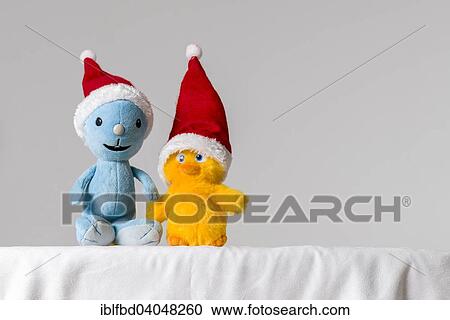 Two plush toys wearing Santa Claus hats View Large Photo Image Stock Image - Two plush toys wearing Santa Claus hats. Fotosearch