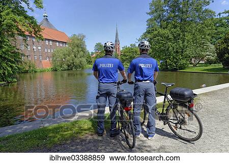 "Two police officers, community liaison officers, with police bicycles, Winsen an der Luhe, Lower Saxony, Germany, Europe" View Large Photo Image Stock Photo - "Two police officers, community liaison officers, with police bicycles, Winsen an der Luhe, Lower Saxony, Germany, Europe". Fotosearch