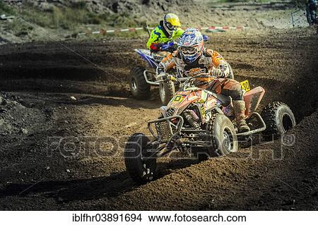 Picture - "Two quad bikes speeding through a curve on a motocross track, Grevenbroich, North Rhine-Westphalia, Germany, Europe". Fotosearch