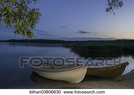 "Two rowing boats, Mazurski Eden or Masurian Garden of Eden, reconstruction of Galindian culture, Gmina Ruciane-Nida, Warmian-Masurian Voivodeship, Poland, Europe" View Large Photo Image Stock Image - "Two rowing boats, Mazurski Eden or Masurian Garden of Eden, reconstruction of Galindian culture, Gmina Ruciane-Nida, Warmian-Masurian Voivodeship, Poland, Europe". Fotosearch
