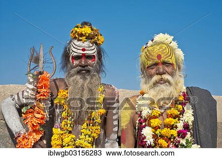 "Two sadhus, holy men with a typical face painting, one holding a Trishula trident, Orchha, Madhya Pradesh, India, Asia" View Large Photo Image Stock Image - "Two sadhus, holy men with a typical face painting, one holding a Trishula trident, Orchha, Madhya Pradesh, India, Asia". Fotosearch