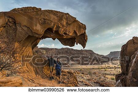 "Two teenagers standing on a rock formation, Lion's Mouth, Twyfelfontein, Namibia, Africa" View Large Photo Image Stock Photograph - "Two teenagers standing on a rock formation, Lion's Mouth, Twyfelfontein, Namibia, Africa". Fotosearch