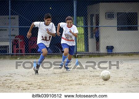"Two teenagers, twins, 16 years, playing football, Craque do Amanha social project, Sao Goncalo, Niteroi, Rio de Janeiro State, Brazil, South America" View Large Photo Image Stock Image - "Two teenagers, twins, 16 years, playing football, Craque do Amanha social project, Sao Goncalo, Niteroi, Rio de Janeiro State, Brazil, South America". Fotosearch