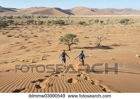 "Two teens running down a dune, Sossusvlei, Namib Desert, Namibia, Africa" View Large Photo Image Stock Photo - "Two teens running down a dune, Sossusvlei, Namib Desert, Namibia, Africa". Fotosearch