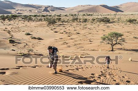 "Two teens running up a dune, Sossusvlei, Namib Desert, Namibia, Africa" View Large Photo Image Stock Image - "Two teens running up a dune, Sossusvlei, Namib Desert, Namibia, Africa". Fotosearch