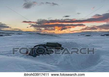 Stock Image - "Two tents in the early morning in winter, Dovre Sunndalsfjella National Park, Norway, Europe". Fotosearch