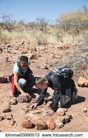 "Two tourists looking for fossilised dinosaur footprints, Kalkfeld, Otjozondjupa Region, Namibia, Africa" View Large Photo Image Stock Image - "Two tourists looking for fossilised dinosaur footprints, Kalkfeld, Otjozondjupa Region, Namibia, Africa". Fotosearch