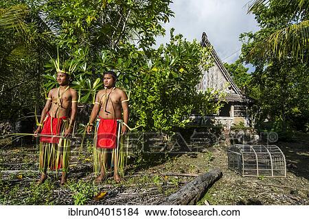 "Two traditionally dressed men standing in front of stone money, Yap Island, Caroline Islands, Micronesia, Oceania" View Large Photo Image Picture - "Two traditionally dressed men standing in front of stone money, Yap Island, Caroline Islands, Micronesia, Oceania". Fotosearch