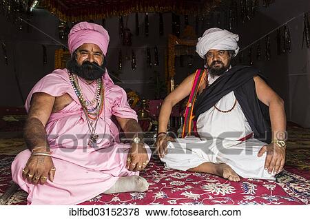 "Two Udaisin Sadhus, holy men, sitting in their tent at the Sangam, the confluence of the rivers Ganges, Yamuna and Saraswati, during Kumbha Mela festival, Allahabad, Uttar Pradesh, India, Asia" View Large Photo Image Stock Photo - "Two Udaisin Sadhus, holy men, sitting in their tent at the Sangam, the confluence of the rivers Ganges, Yamuna and Saraswati, during Kumbha Mela festival, Allahabad, Uttar Pradesh, India, Asia". Fotosearch
