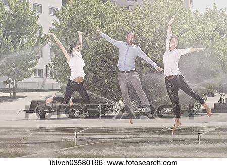 "Two women and one man jumping in the park, between water sprinklers, Innsbruck, Tyrol, Austria, Europe" View Large Photo Image Stock Photograph - "Two women and one man jumping in the park, between water sprinklers, Innsbruck, Tyrol, Austria, Europe". Fotosearch