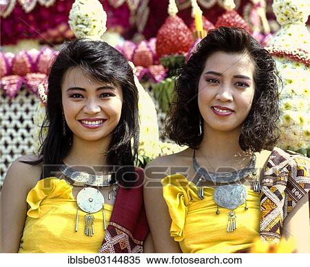 Stock Photography - "Two women at the Flower Festival on a decorated float, Chiang Mai, Northern Thailand, Thailand, Asia". Fotosearch