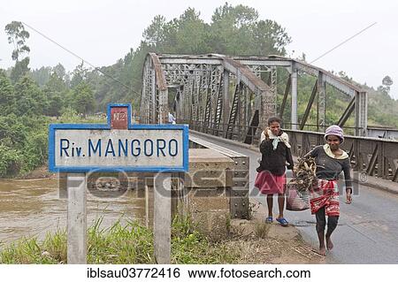 "Two women crossing an old iron bridge over the Mangoro River, near Antananarivo, Madagascar, Africa" View Large Photo Image Stock Photograph - "Two women crossing an old iron bridge over the Mangoro River, near Antananarivo, Madagascar, Africa". Fotosearch