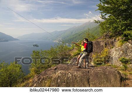 "Two women hiking, Balladrum, viewpoint overlooking lake Lago Maggiore, Ticino, Switzerland, Europe" View Large Photo Image Stock Image - "Two women hiking, Balladrum, viewpoint overlooking lake Lago Maggiore, Ticino, Switzerland, Europe". Fotosearch