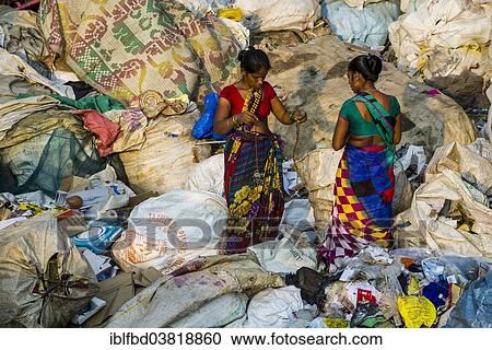 "Two women in colorful saris are sorting out garbage for recycling, at Dharavi Slum, Mumbai, Maharashtra, India, Asia" View Large Photo Image Stock Image - "Two women in colorful saris are sorting out garbage for recycling, at Dharavi Slum, Mumbai, Maharashtra, India, Asia". Fotosearch