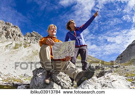 "Two women reading map of trails, Val dal Botsch, Swiss National Park, Graubunden, Switzerland, Europe" View Large Photo Image Picture - "Two women reading map of trails, Val dal Botsch, Swiss National Park, Graubunden, Switzerland, Europe". Fotosearch