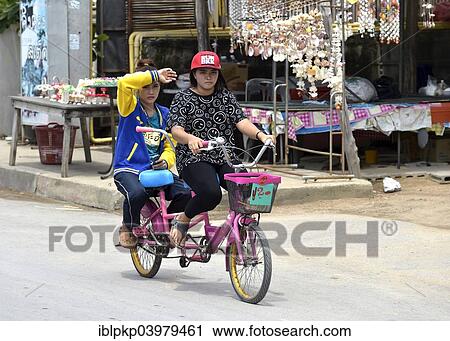 "Two women riding a tandem, Cha Am, Thailand, Asia" View Large Photo Image Stock Image - "Two women riding a tandem, Cha Am, Thailand, Asia". Fotosearch