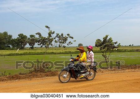 "Two women riding on a motorcycle on a country road, Cambodia, Asia" View Large Photo Image Stock Image - "Two women riding on a motorcycle on a country road, Cambodia, Asia". Fotosearch