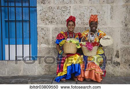 "Two women wearing colourful dresses, Havana, Cuba, North America" View Large Photo Image Stock Image - "Two women wearing colourful dresses, Havana, Cuba, North America". Fotosearch