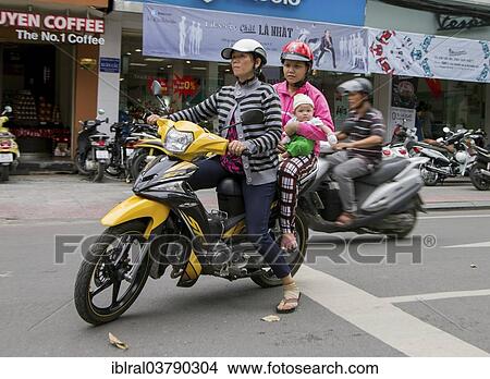 "Two women with child on a motorcycle, Ho Chi Minh City, Vietnam, Asia" View Large Photo Image Picture - "Two women with child on a motorcycle, Ho Chi Minh City, Vietnam, Asia". Fotosearch