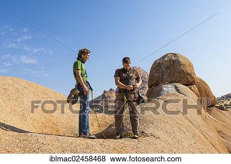"Two young climbers at Bogenfels, Spitzkoppe, Namibia, Africa" View Large Photo Image Stock Photo - "Two young climbers at Bogenfels, Spitzkoppe, Namibia, Africa". Fotosearch