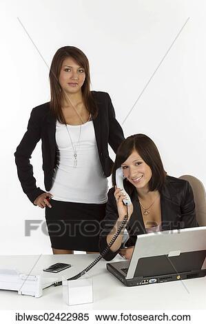 Two young women in an office View Large Photo Image Stock Photography - Two young women in an office. Fotosearch