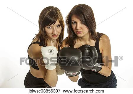 Stock Photo - "Two young women in sports clothing, one wearing Wing Chun gloves, the other wearing boxing gloves". Fotosearch