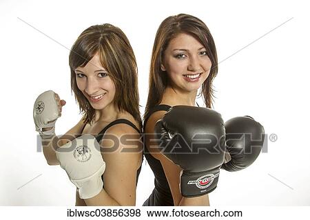"Two young women in sports clothing, one wearing Wing Chun gloves, the other wearing boxing gloves" View Large Photo Image Stock Photo - "Two young women in sports clothing, one wearing Wing Chun gloves, the other wearing boxing gloves". Fotosearch
