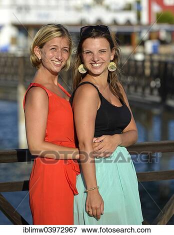 Stock Photo - "Two young women posing on the redesigned promenade of Playa Blanca, Lanzarote, Canary Islands, Spain, Europe". Fotosearch