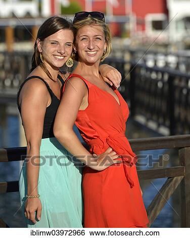 Stock Photograph - "Two young women posing on the redesigned promenade of Playa Blanca, Lanzarote, Canary Islands, Spain, Europe". Fotosearch