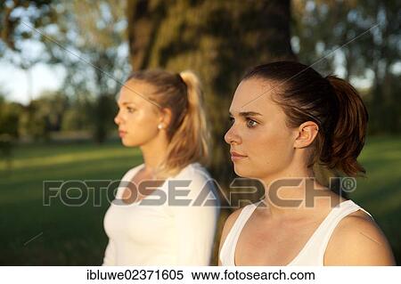 Two young women relaxing outdoors View Large Photo Image Stock Photography - Two young women relaxing outdoors. Fotosearch