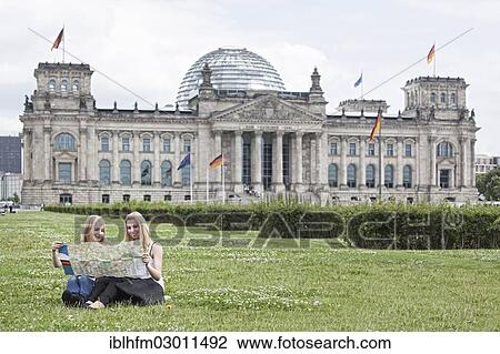 "Two young women studying a map of Berlin, sitting on a lawn in front of the Reichstag building, Berlin Reichstag, Berlin, Berlin, Germany, Europe" View Large Photo Image Stock Image - "Two young women studying a map of Berlin, sitting on a lawn in front of the Reichstag building, Berlin Reichstag, Berlin, Berlin, Germany, Europe". Fotosearch