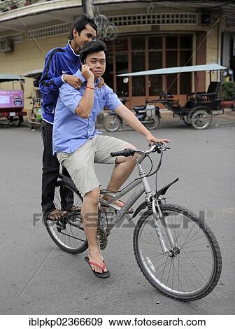 "Two youths on a bike, Phnom Penh, Cambodia, Southeast Asia, Asia" View Large Photo Image Stock Photo - "Two youths on a bike, Phnom Penh, Cambodia, Southeast Asia, Asia". Fotosearch