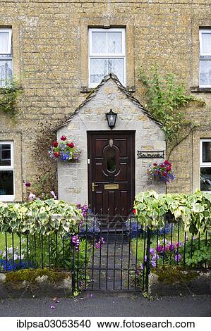 Stock Image - "Typical facade of a house in old town, Bourton in the Water, Cotswold, Gloucestershire, England, United Kingdom, Europe". Fotosearch
