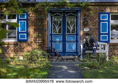 "Typical house entrance with a bench and figures made of stone, Wustrow, Fischland, Mecklenburg-Western Pomerania, Germany, Europe" View Large Photo Image Stock Photo - "Typical house entrance with a bench and figures made of stone, Wustrow, Fischland, Mecklenburg-Western Pomerania, Germany, Europe". Fotosearch