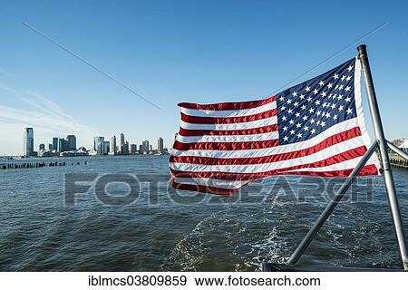 "U. S. flag, behind the southern tip of Manhattan, New York City, New York, USA" View Large Photo Image Stock Photo - "U. S. flag, behind the southern tip of Manhattan, New York City, New York, USA". Fotosearch