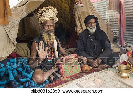 "Udaisin Sadhu, holy man, sitting in his tent at the Sangam, the confluence of the rivers Ganges, Yamuna and Saraswati, during Kumbha Mela festival, Allahabad, Uttar Pradesh, India, Asia" View Large Photo Image Stock Photo - "Udaisin Sadhu, holy man, sitting in his tent at the Sangam, the confluence of the rivers Ganges, Yamuna and Saraswati, during Kumbha Mela festival, Allahabad, Uttar Pradesh, India, Asia". Fotosearch